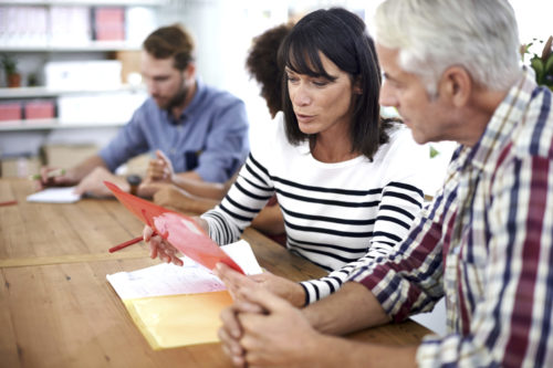 Two business professionals having a discussion in a meeting